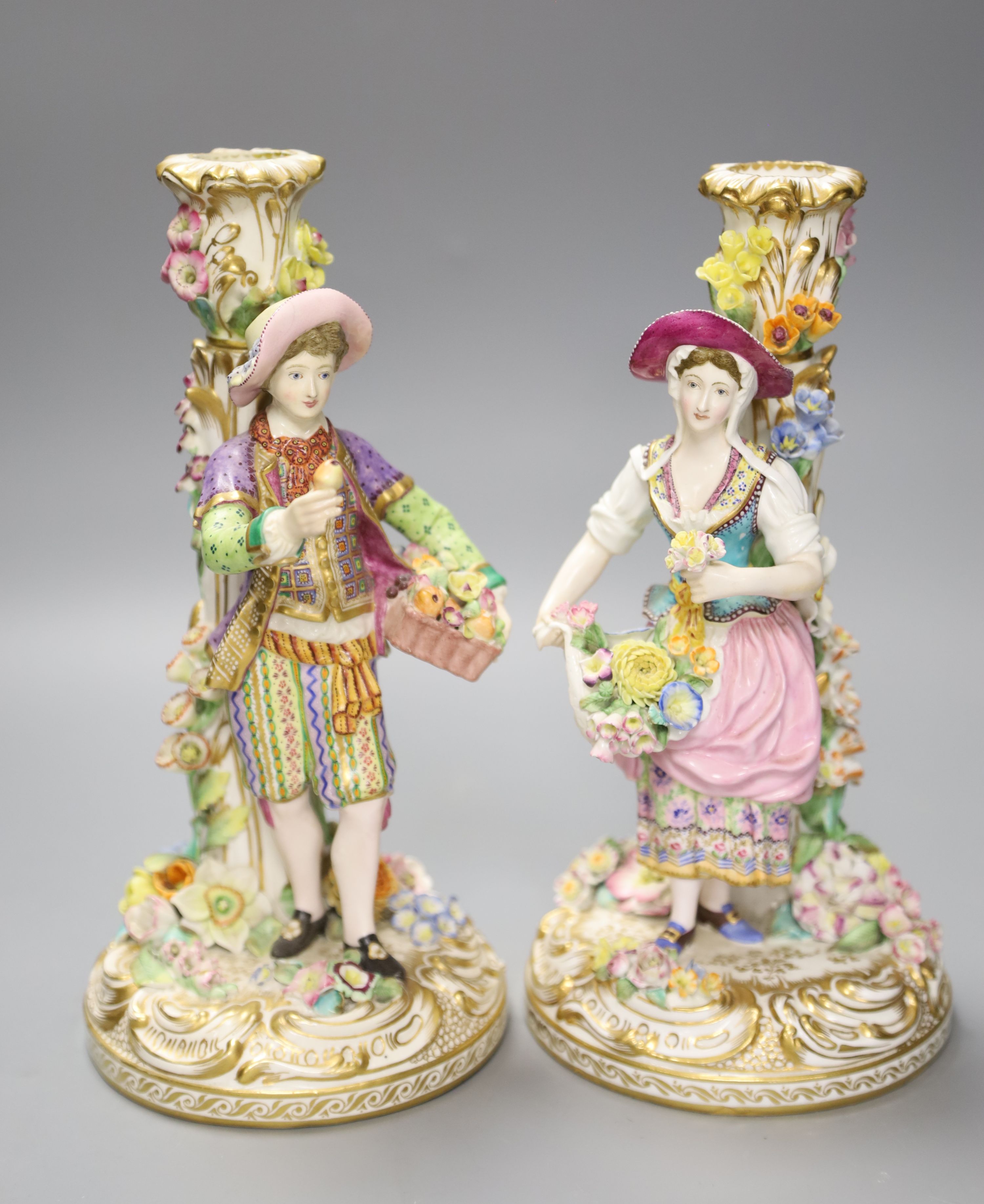 A pair of 19th century Minton figural candlesticks of a boy and girl, height 23cm